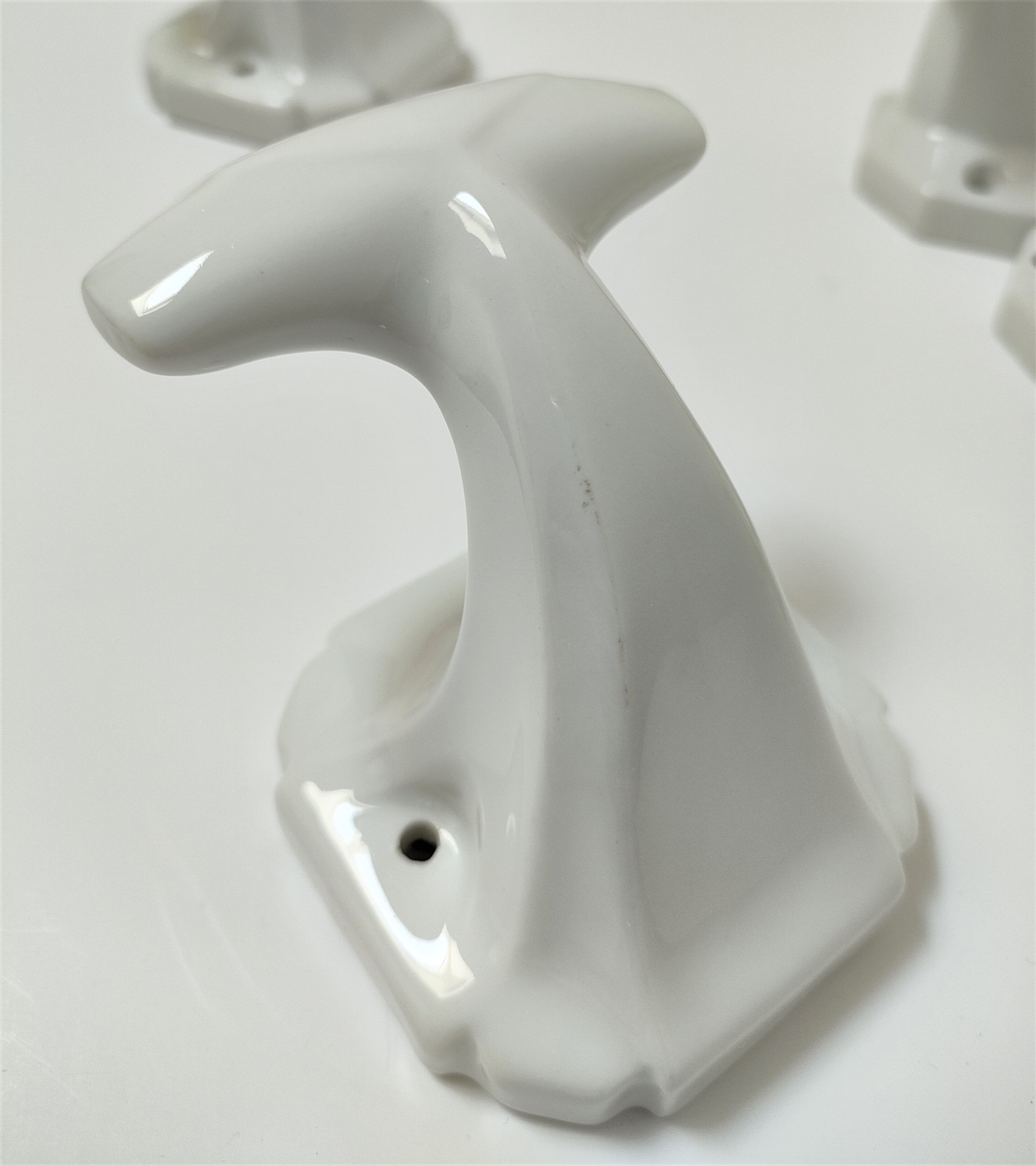Five art deco white porcelain hooks