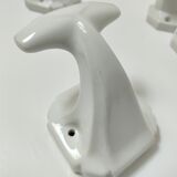 Five art deco white porcelain hooks