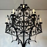 Lustre with 12 lights in wrought iron decorated with clovers and foliage.
