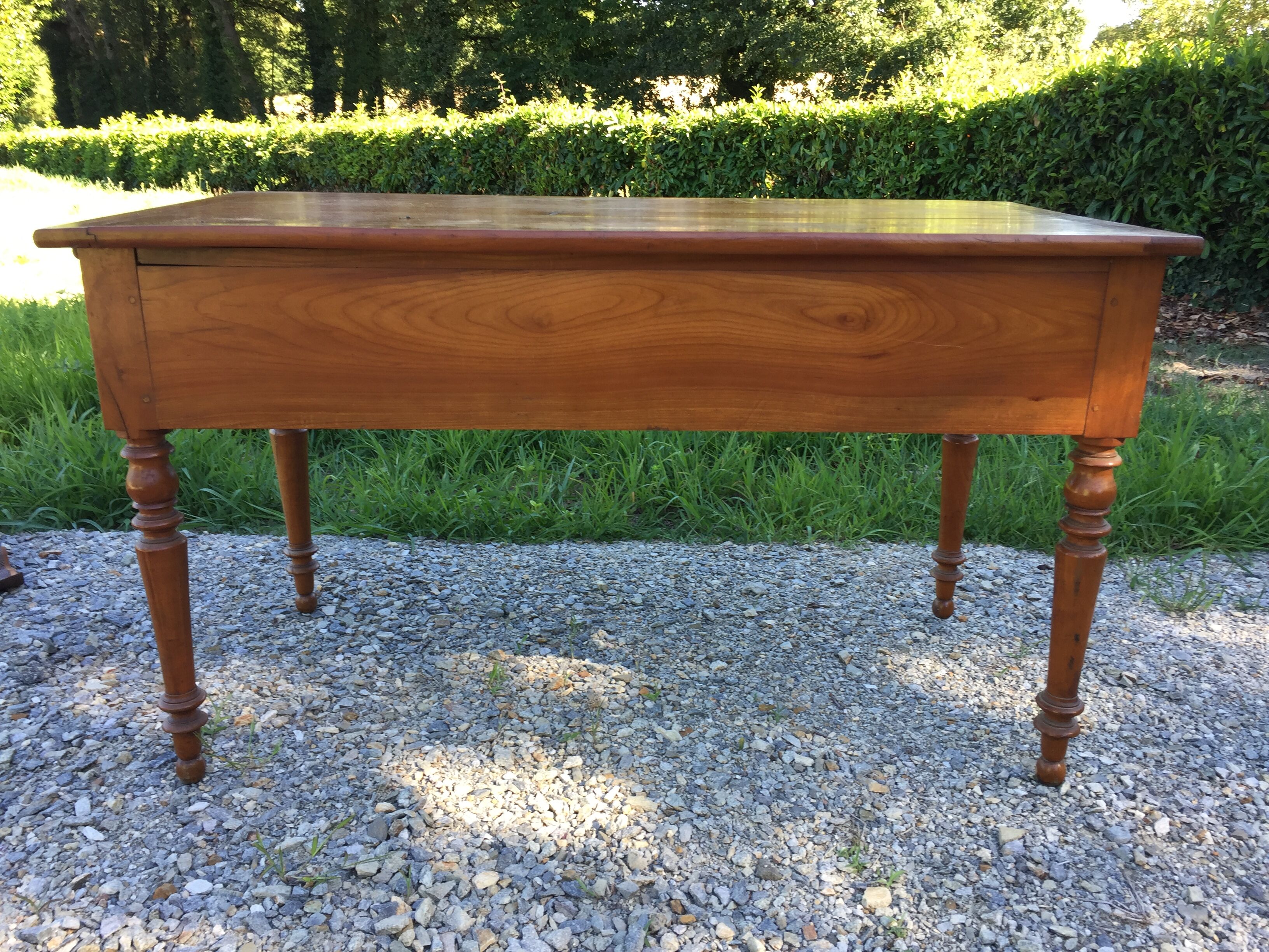 Old farmhouse table louis Philippe style in solid cherry with turned feet.