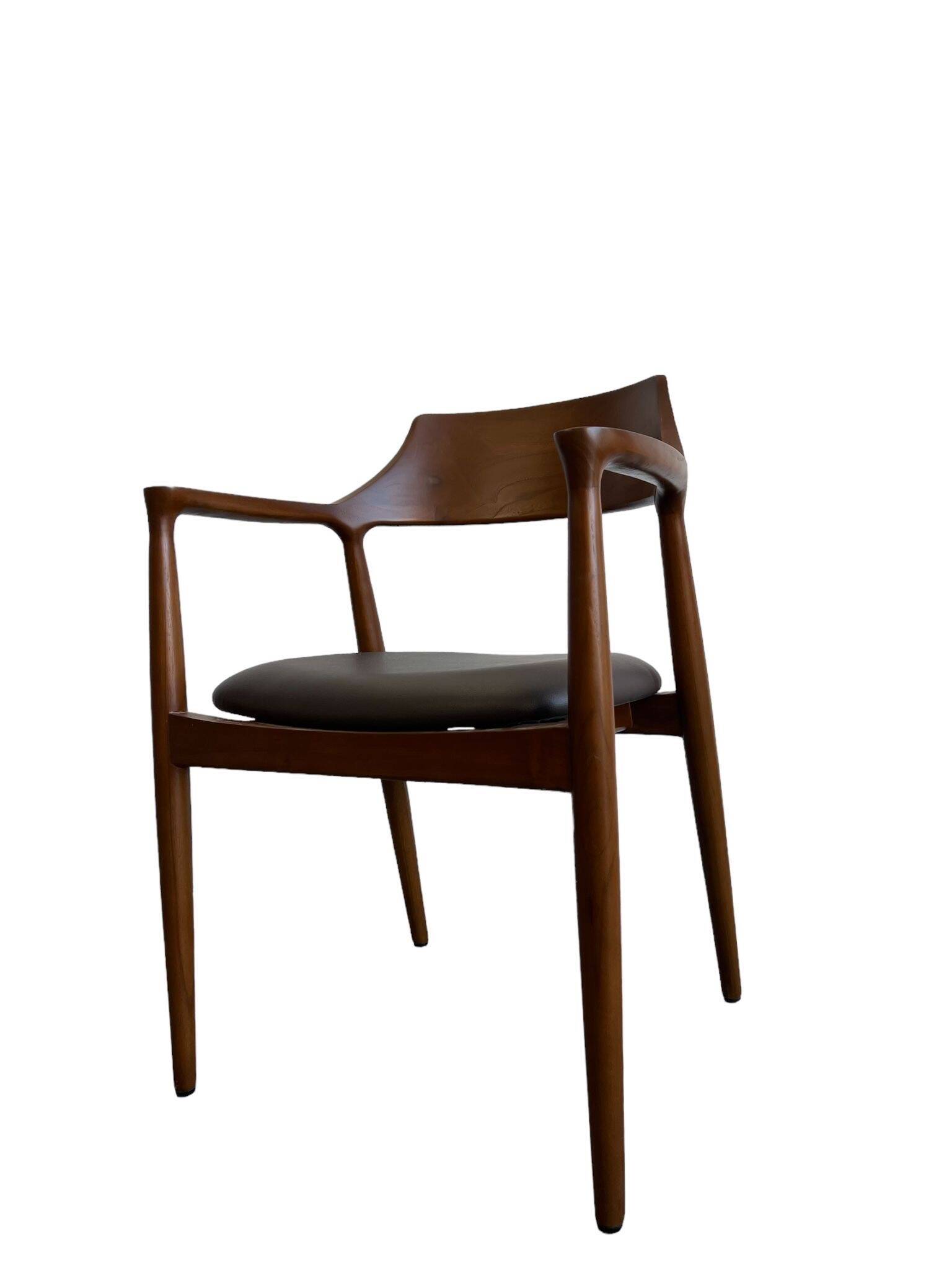 Curved wooden dining chair with brown leather seat