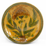 Bulgarian artisanal plate with autumn-hued flower