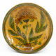 Bulgarian artisanal plate with autumn-hued flower