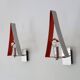 Pair of triangular wall sconces in chrome metal and orange. 1970s.