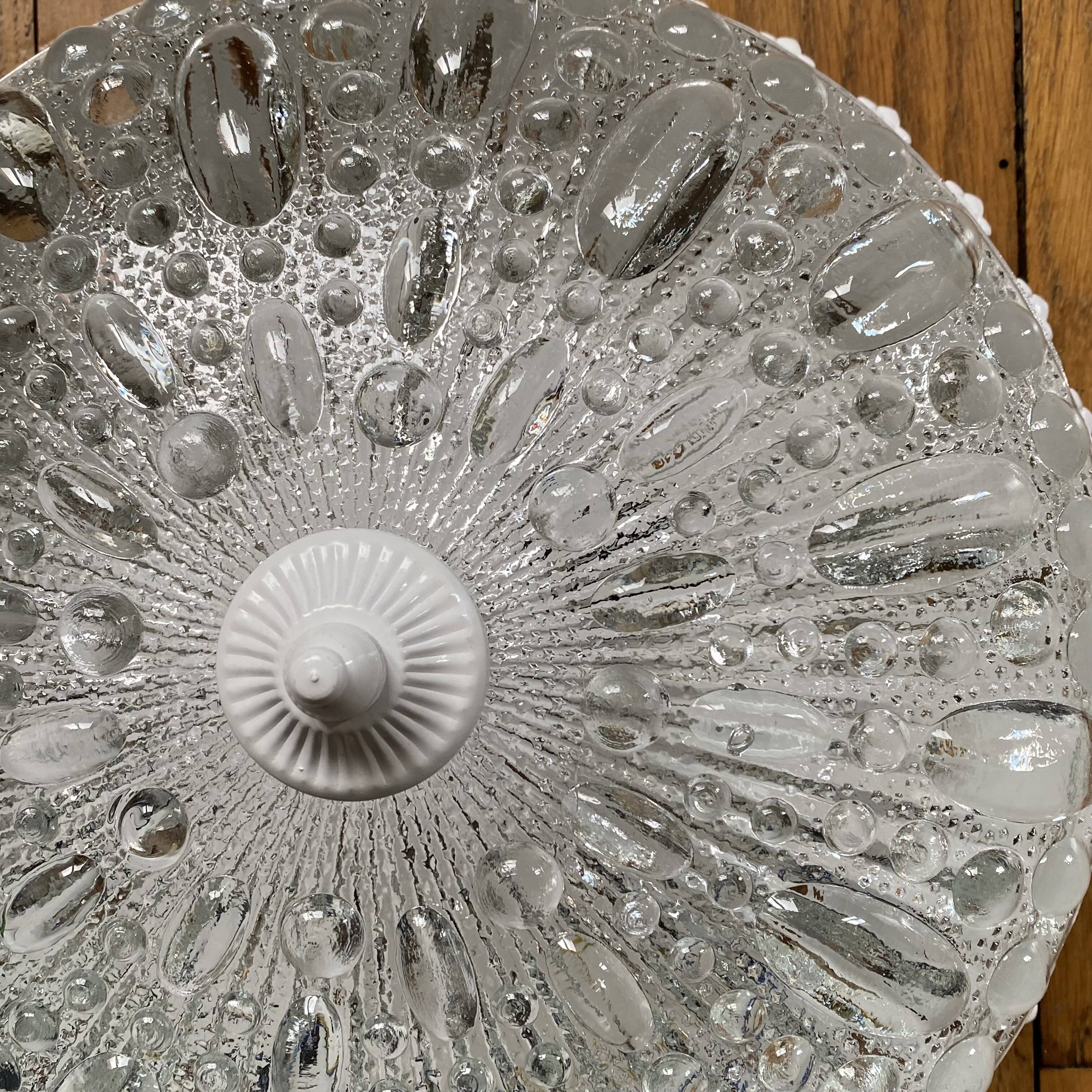 Antique ceiling light with transparent glass and white metal.