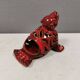Beautiful seal in ceramic with metallic red glaze.