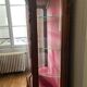 Large wooden display cabinet in Louis XV/rococo style with a strongly curved front.