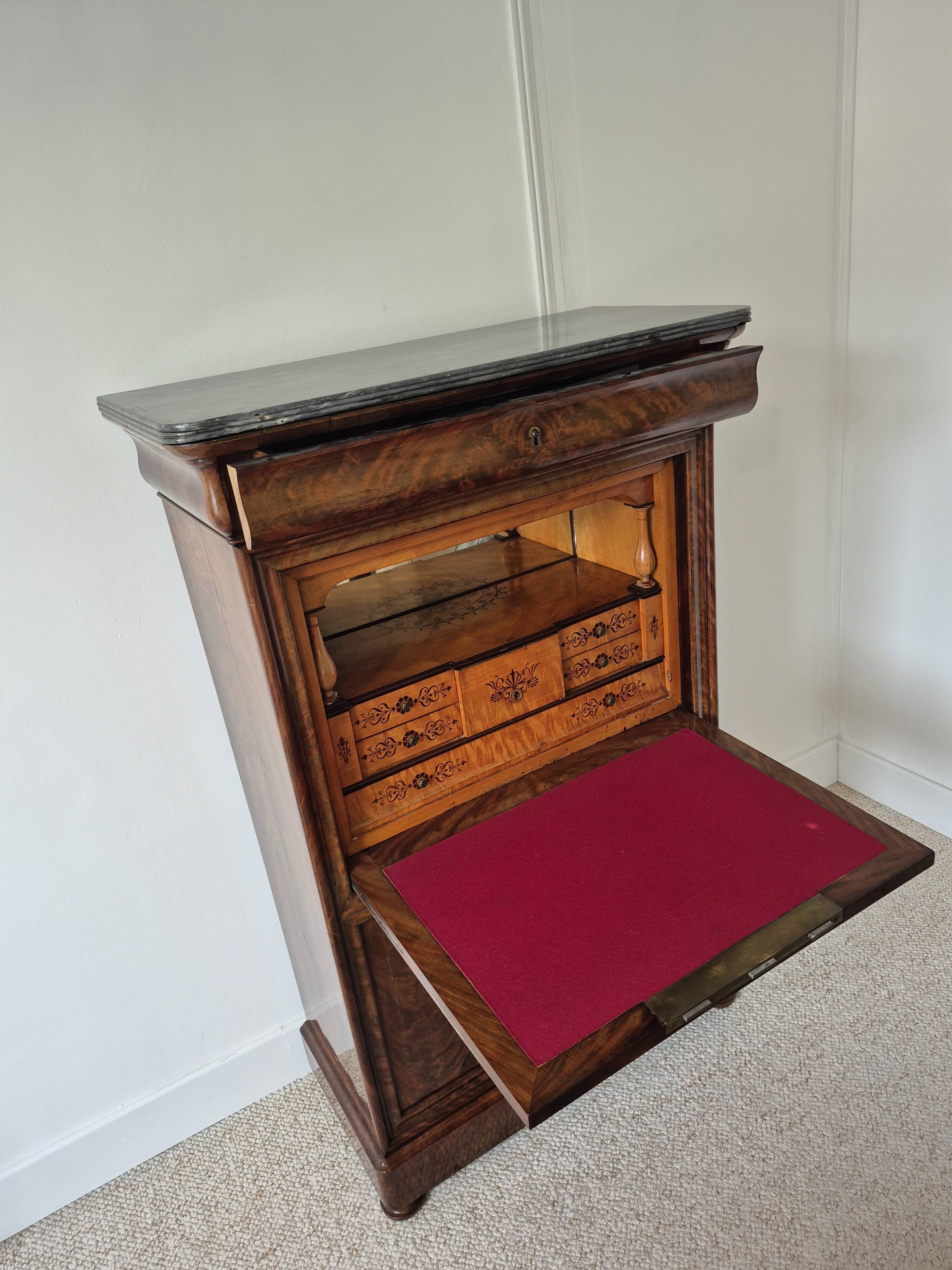 Mahogany secretary desk with marble top and interior mirror.
