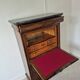 Mahogany secretary desk with marble top and interior mirror.