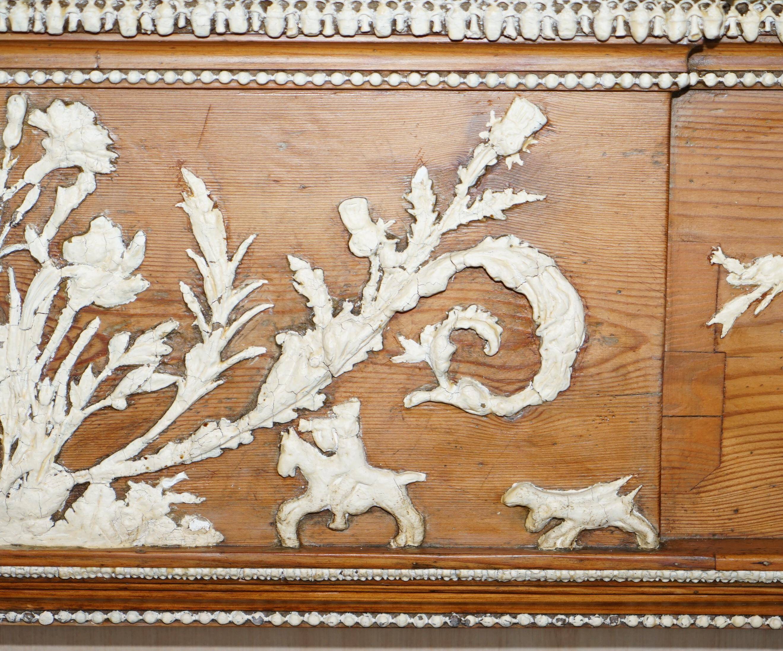 Victorian antique fireplace in tarred pine and sculpted gesso.