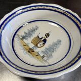 Large earthenware centerpiece dish with painted decoration of a drummer