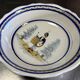 Large earthenware centerpiece dish with painted decoration of a drummer