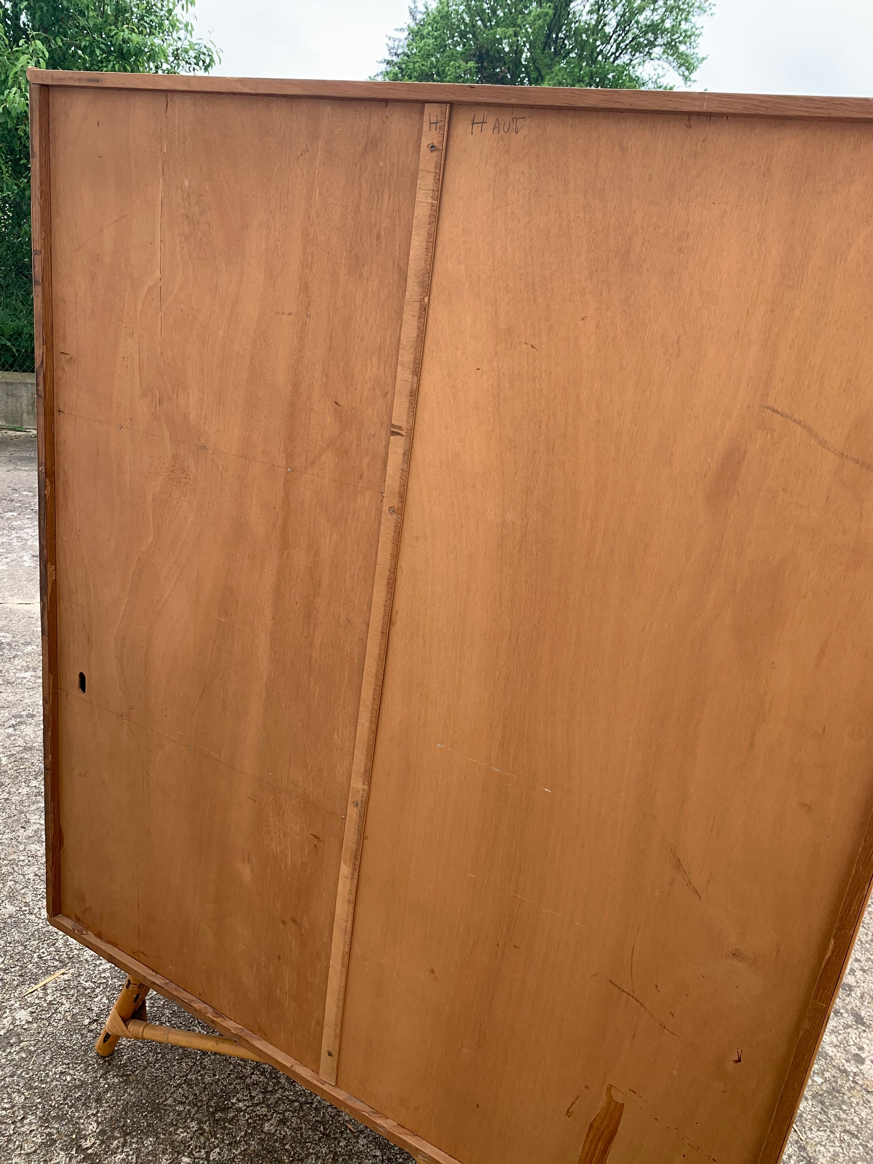Rattan wardrobe with tapered legs from the 1960s.