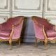 Pair of Louis XV style bergère armchairs in carved wood, pink velvet, circa 1900