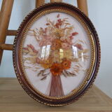 Medallion of dried flowers with a domed frame