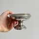 Small silver-plated metal bowl on a stand.