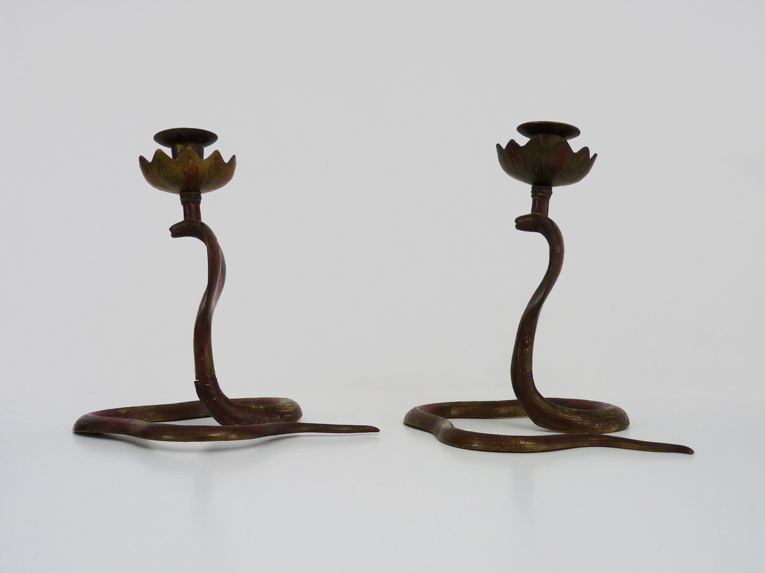 Pair of old bronze cobra candle holders with detailed engraving. Around 1950