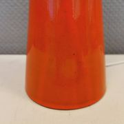Ceramic table lamp with partial orange glaze.