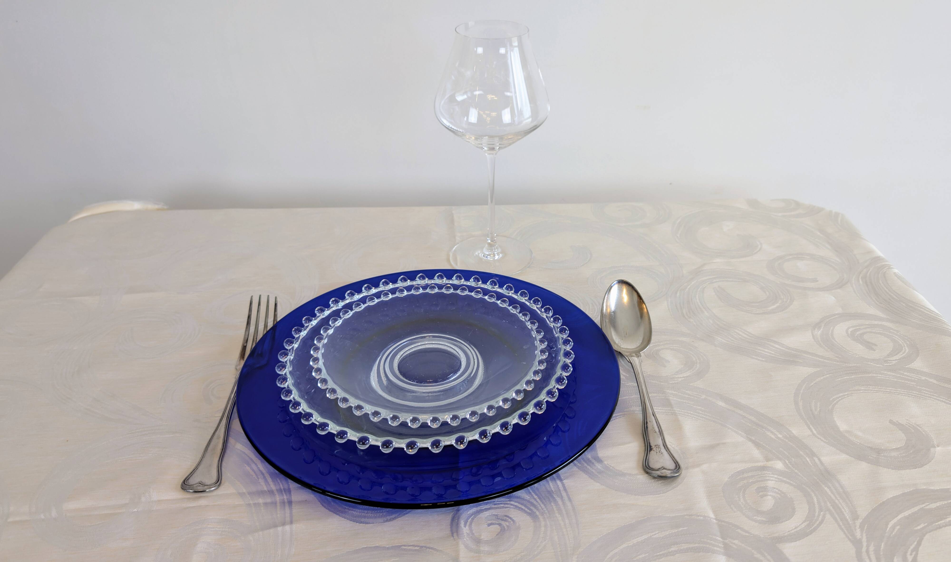 Vintage service of 12 pressed glass plates with bead decoration.