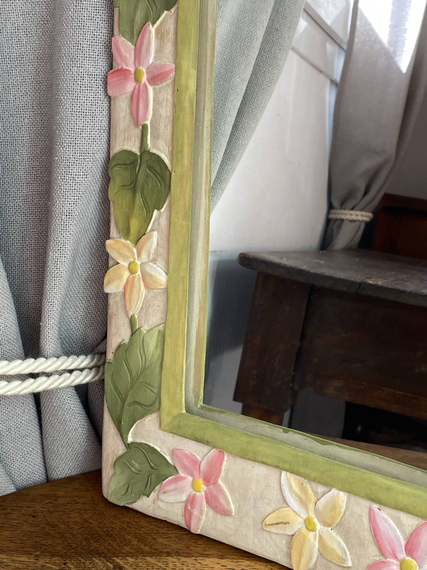 Carved wooden mirror, colourful floral decoration.