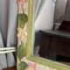 Carved wooden mirror, colourful floral decoration.