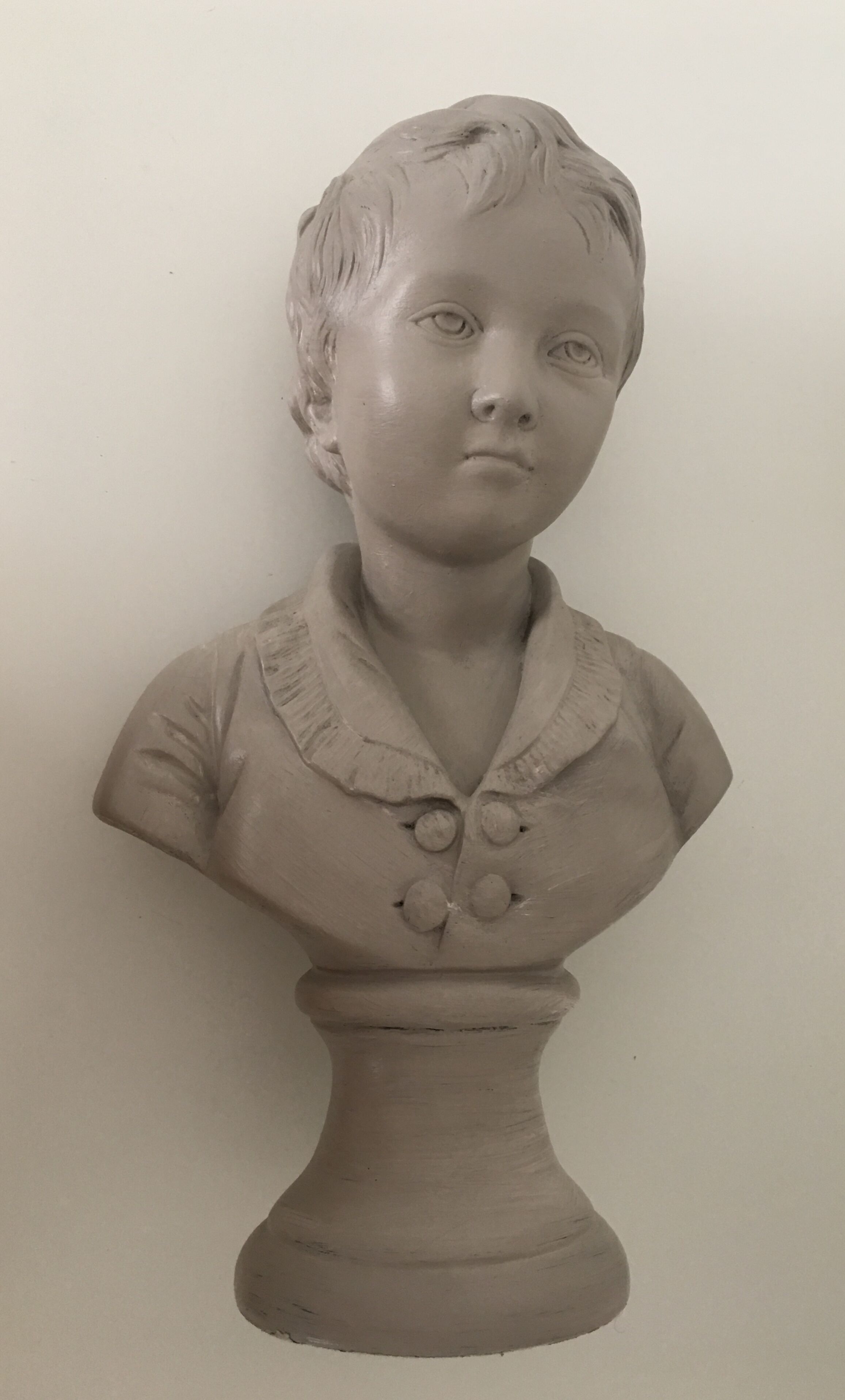 Cherub bust in platter