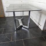 Chromed metal table with smoked glass top
