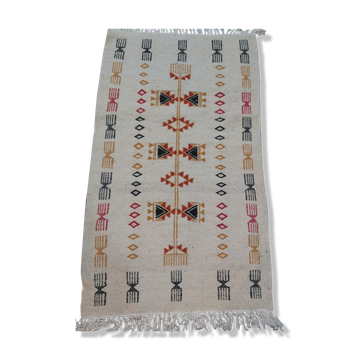 White kilim carpet with multicolored Berber patterns