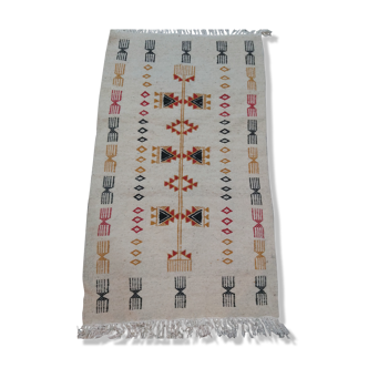 White kilim carpet with multicolored Berber patterns