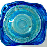 Blown blue glass bottle with inclusions