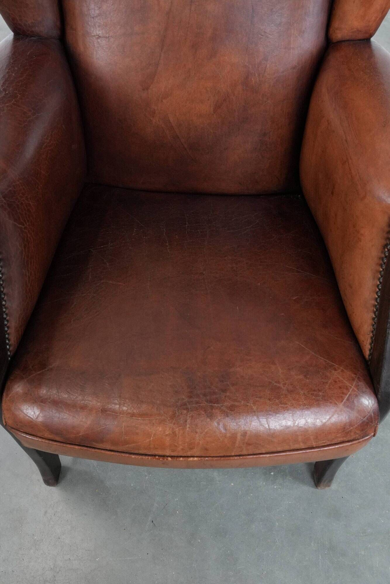 Classic vintage wingback chair in sheepskin and wood