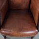 Classic vintage wingback chair in sheepskin and wood