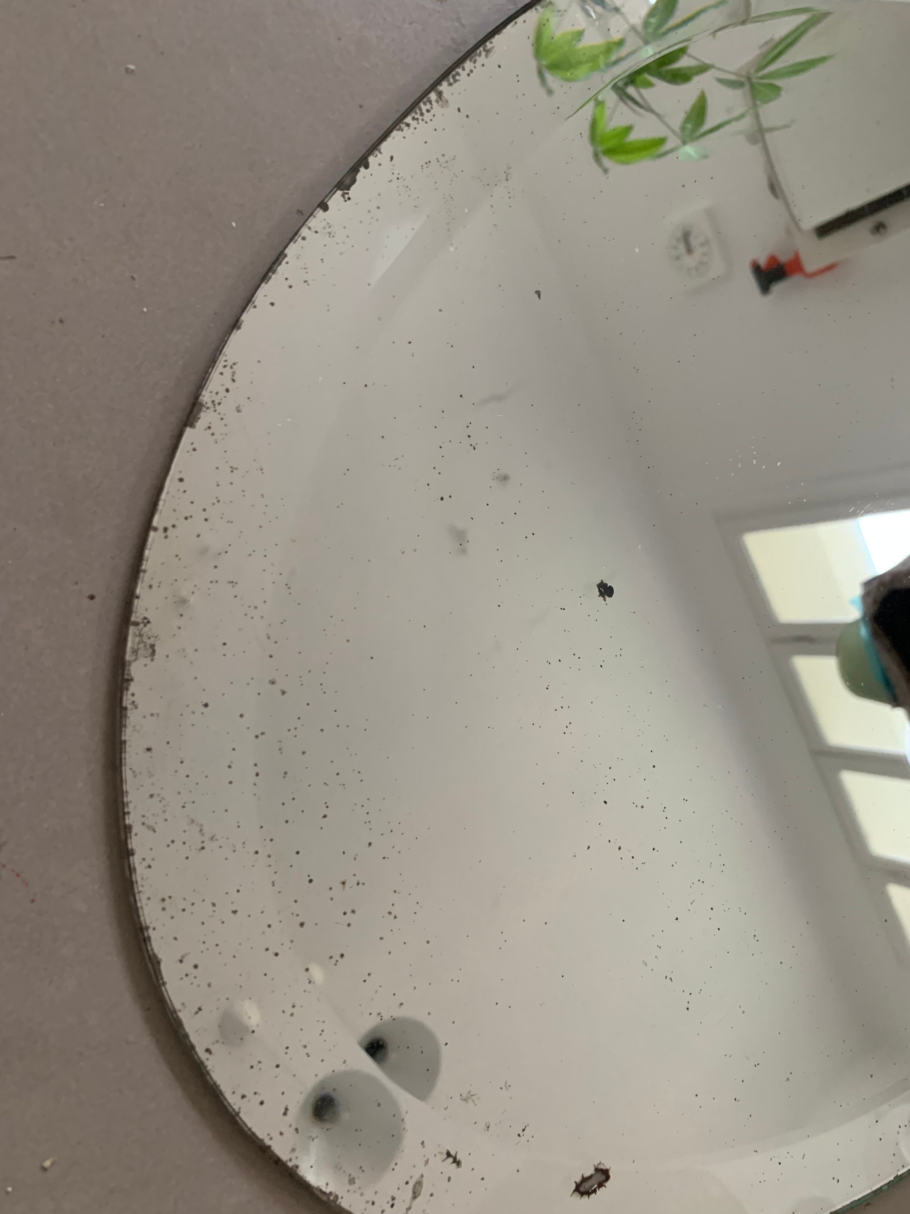 Old bevelled stitched oval mirror