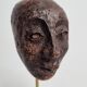 Expressive sculpted head in patinated terracotta on wooden base, 14 cm