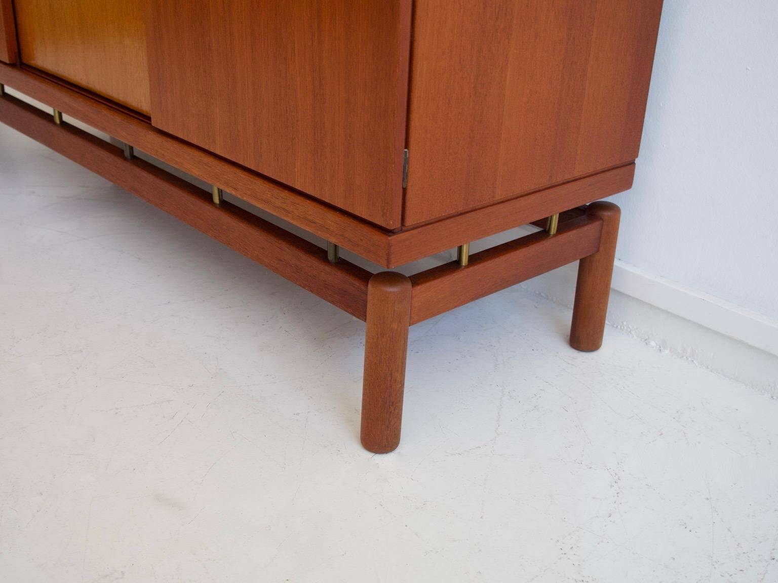 Modern mid-century teak sideboard with brass details.