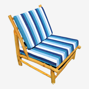 Low armchair in eucalyptus wood with blue and white cushions