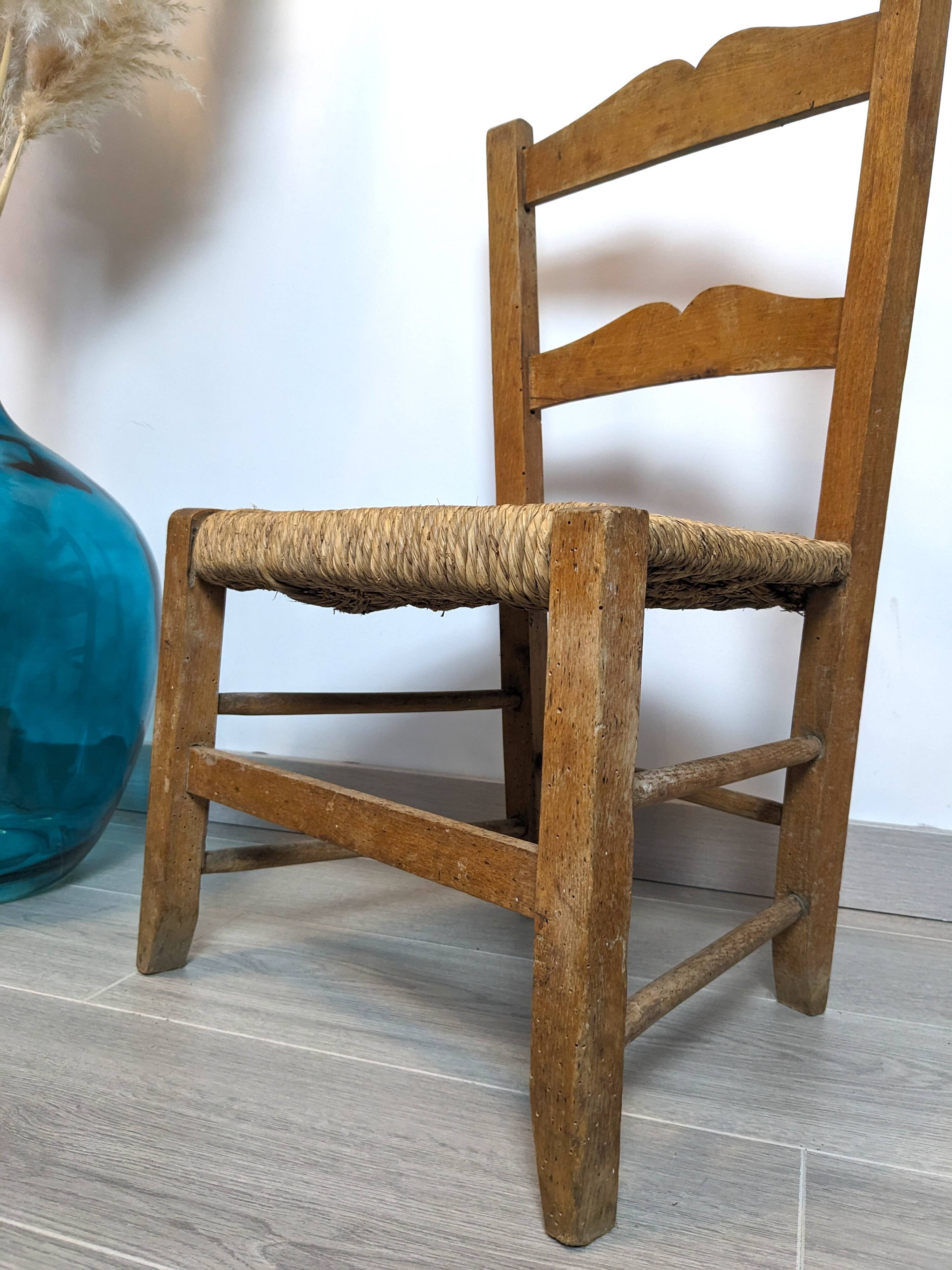 Vintage wooden and straw children's chair in a country style.