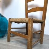 Vintage wooden and straw children's chair in a country style.