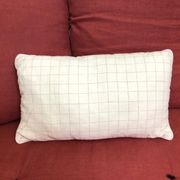 Beige linen cushion with checkered pattern and shiny silver piping