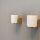 Wall lamps with milky white acrylic plastic shades and solid brass bases