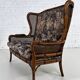Wingback 2-seater sofa in carved wood, cane and fabric