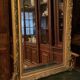 Golden mirror with bevelled ice pediment in Regency style