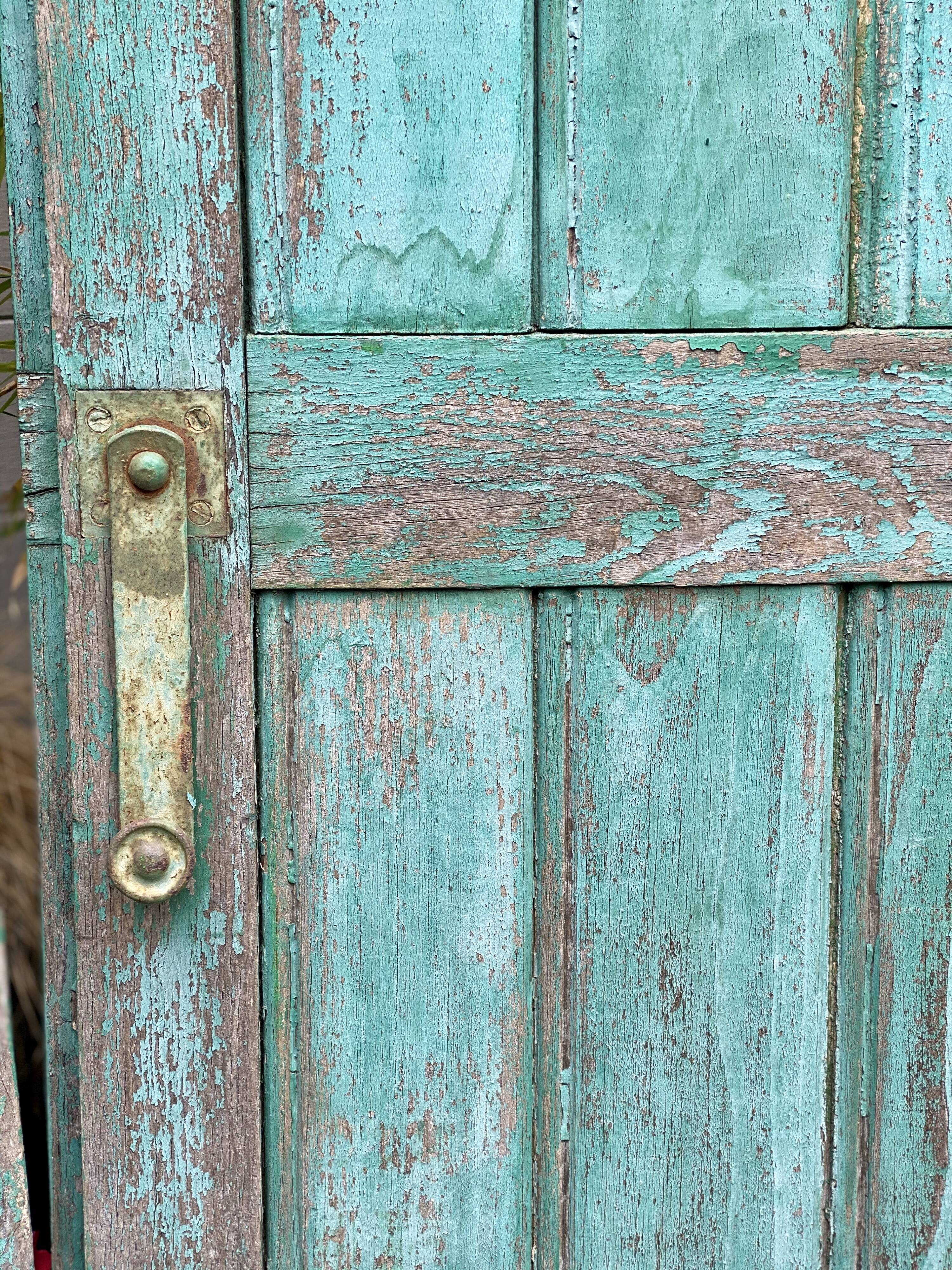 Pair of old wooden shutters green mint color