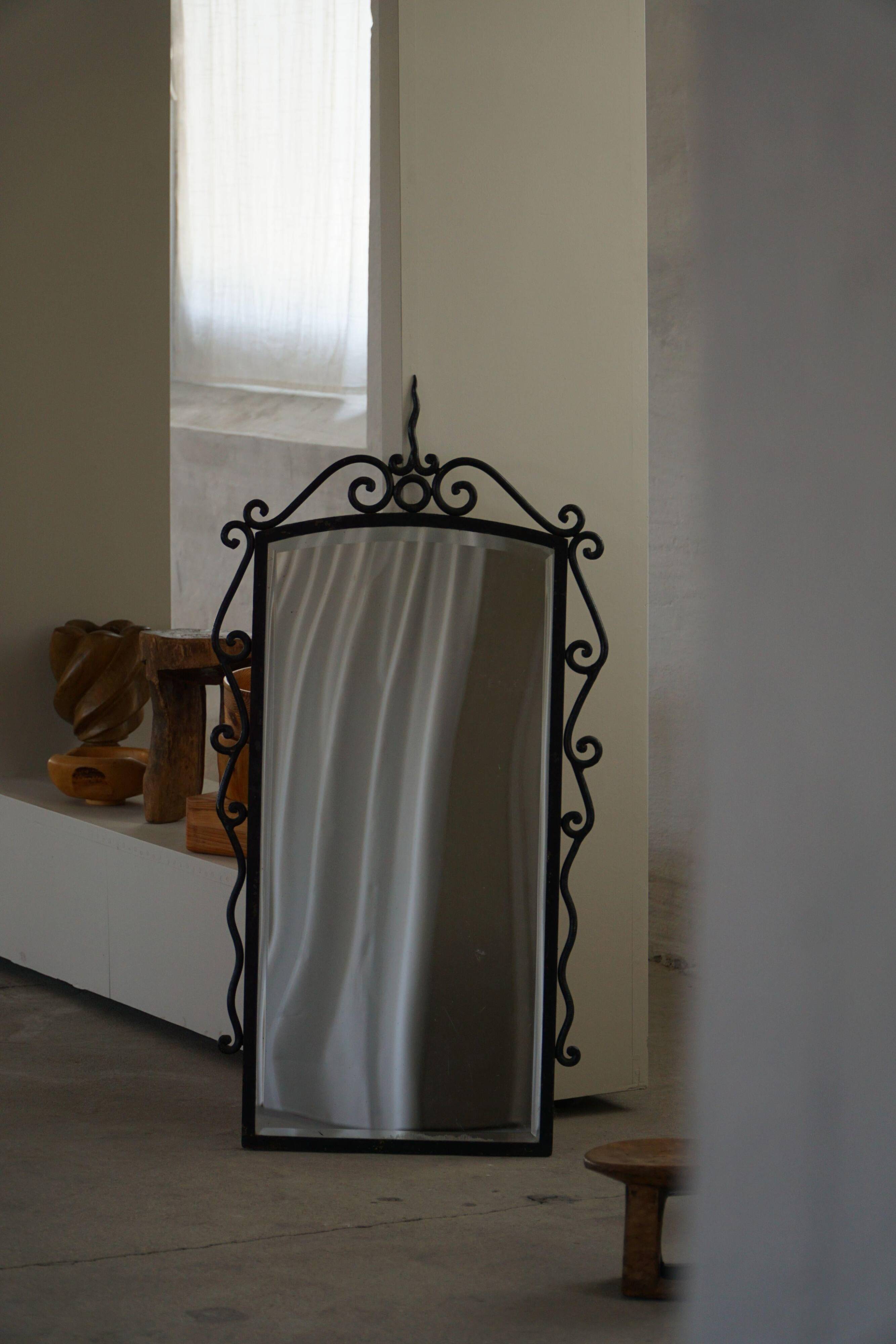 French mid-century brutalist wall mirror in wrought iron, made in the 1950s.