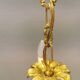 Older brass alloy chandelier with three light sources.