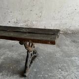Dark brown wood and black cast-iron antique garden bench with weathered solid-wood seat