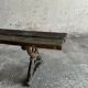 Dark brown wood and black cast-iron antique garden bench with weathered solid-wood seat