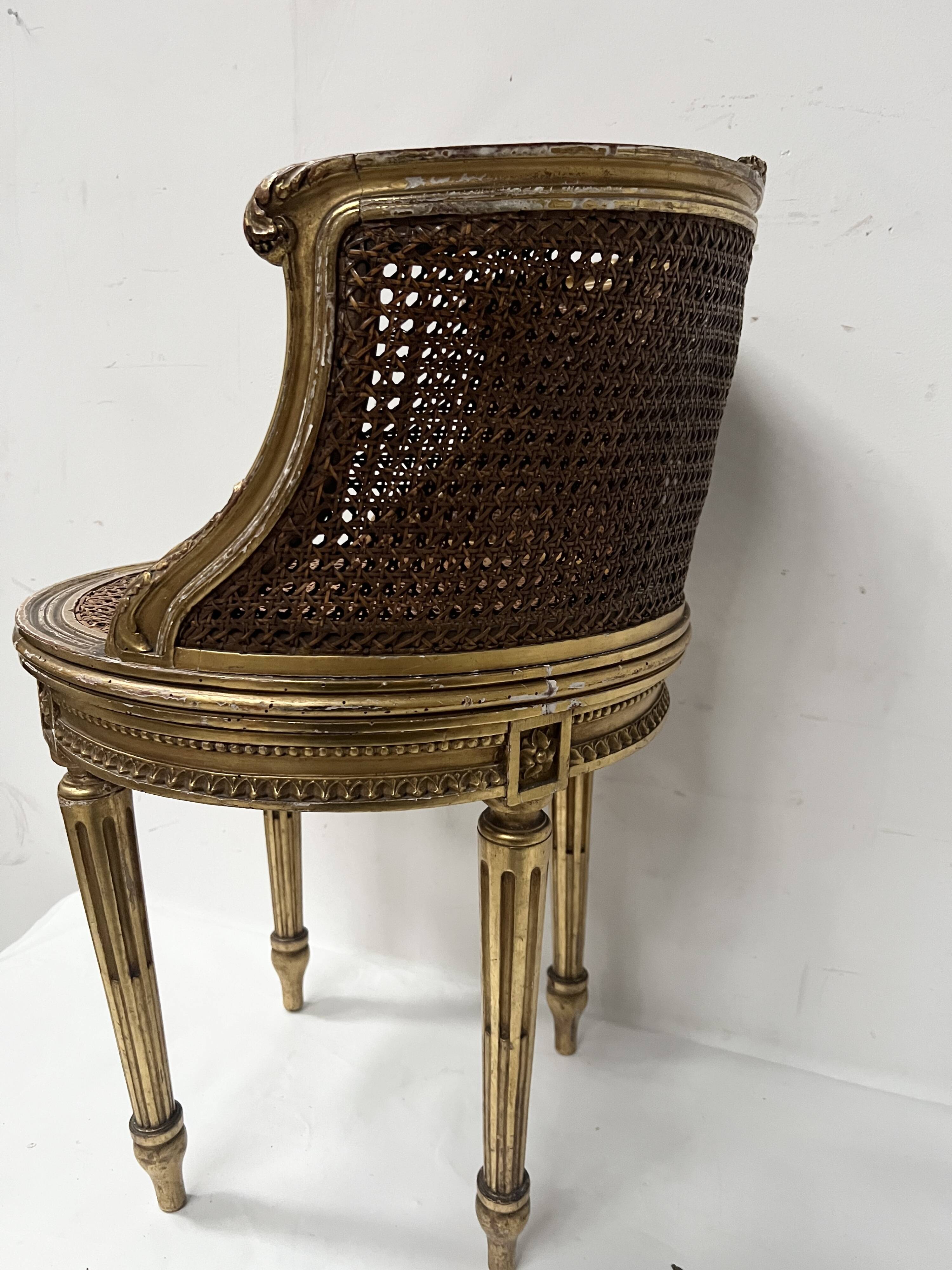 Louis XVI style armchair in wood and gilded stucco, 20th century.
