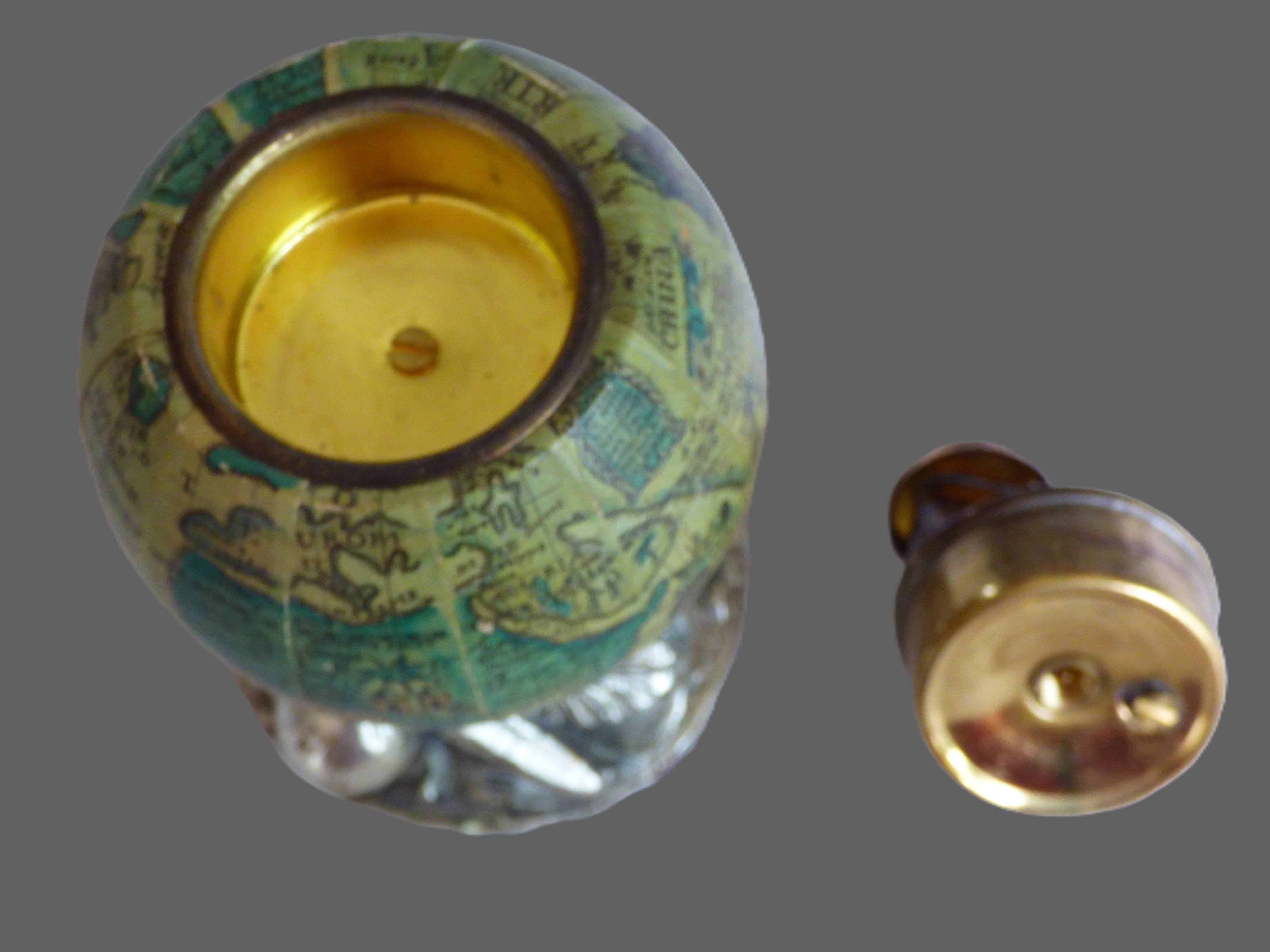 Vintage antique lighter with a globe and silver-plated stand.