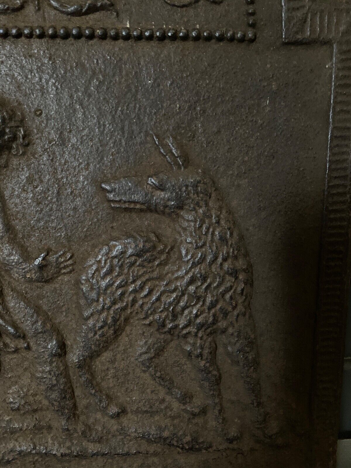 EIGHTEENTH CENTURY CAST IRON FIREPLACE PLATE REPRESENTING A WOMAN AND A WOLF